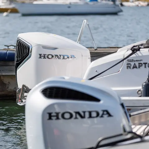 Gruppe von Personen beim Tauchen von einem Honwave mit Honda-Motor aus auf einem See.
