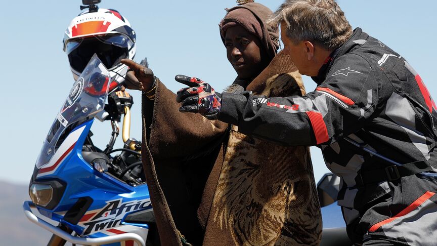 Motorradfahrer unterwegs auf unwegsamem Terrain in Südafrika.