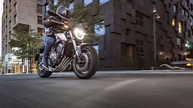CB650R Neo Sports Café, 3/4-Ansicht rechts, in der Stadt mit Fahrer